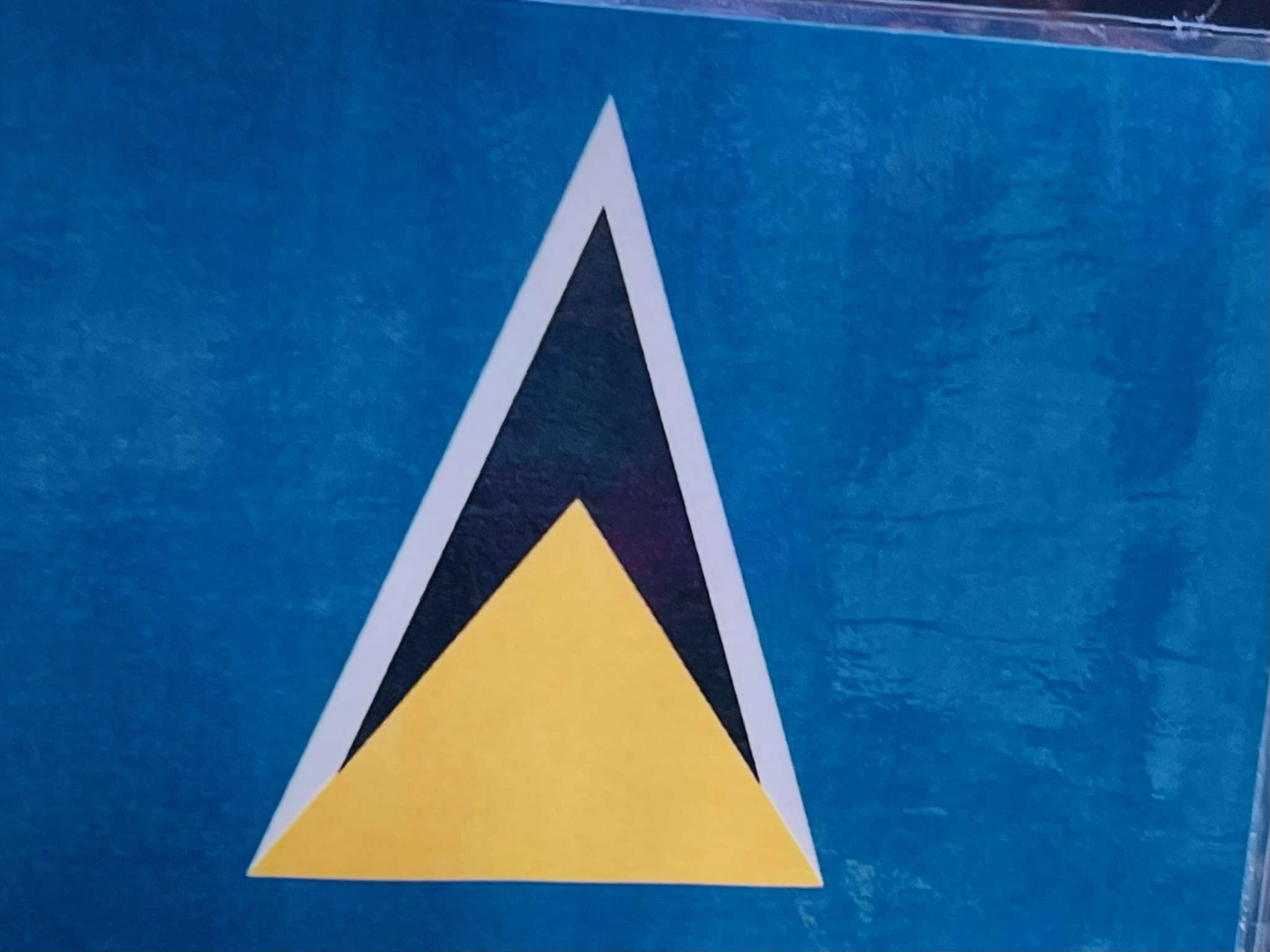 Yellow on dark blue on white triangles on light blue background